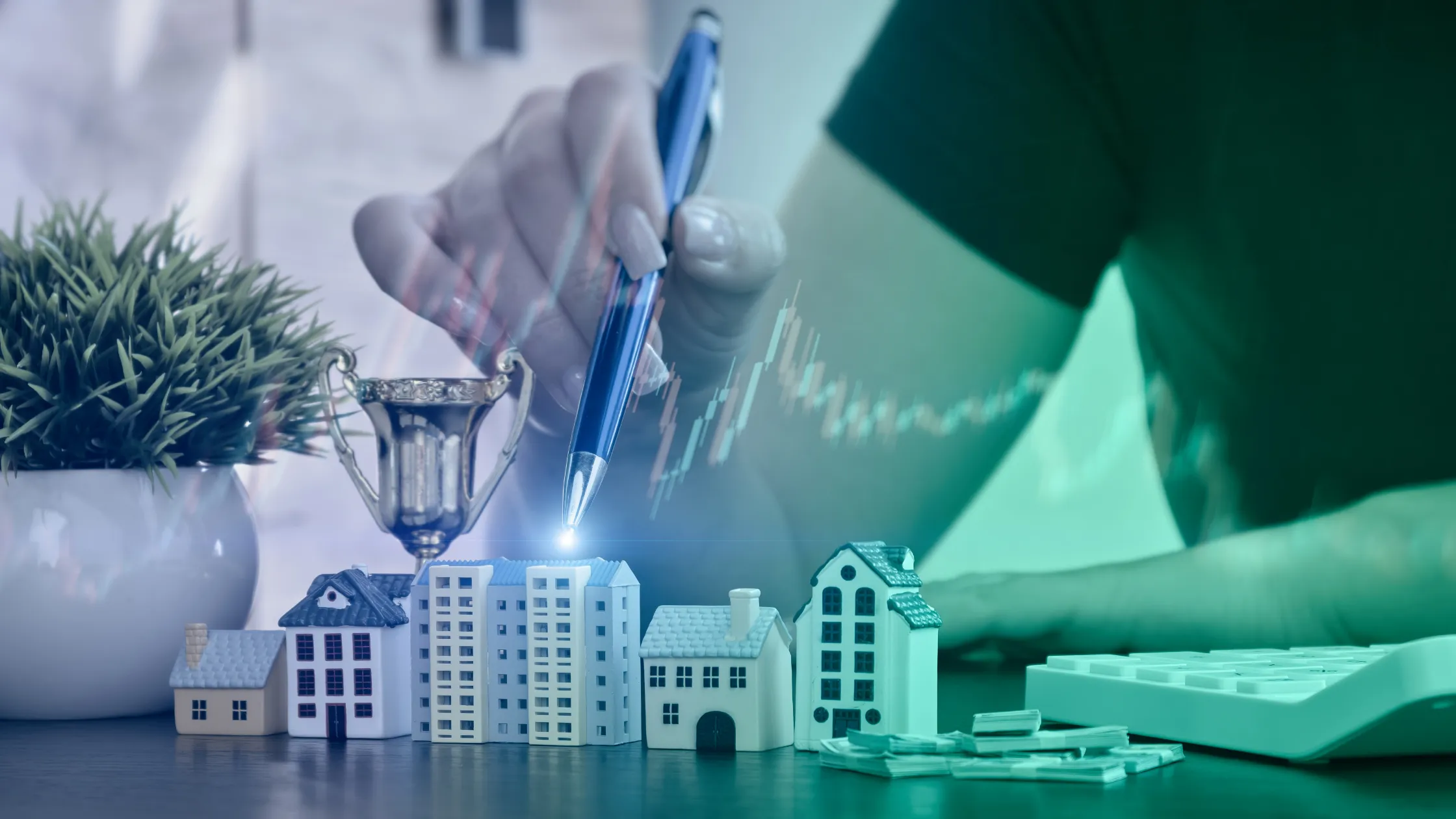 A hand using a pen to point at miniature buildings and financial charts, representing real estate corporate governance, RERA compliance, and project investment tracking.